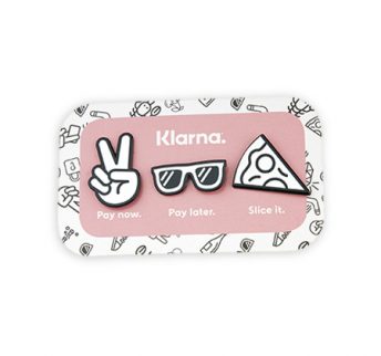 Set of three custom enamel badges on pink rectangle backing card for Swedish online financial services company - Klarna