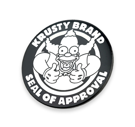 Round black custom enamel badge with white illustrations for Krusty brand fan merchandise