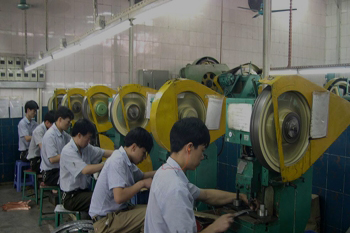 Workers at the badge factory cutting badges